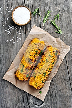 Grilled corn cobs on wooden background