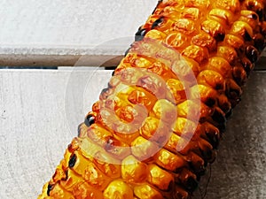 Ear of grilled corn on a table