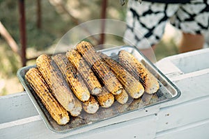 Grilled corn on a silver plate