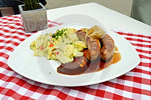 Grilled country sausages served with potatoes in salted