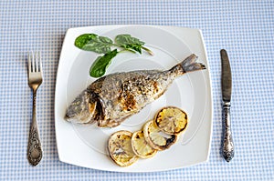 Grilled dorada fish with lemon and spinach