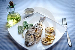 Grilled dorada fish with lemon and spinach