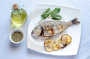 Grilled dorada fish with lemon and spinach