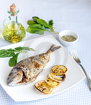 Grilled dorada fish with lemon and spinach