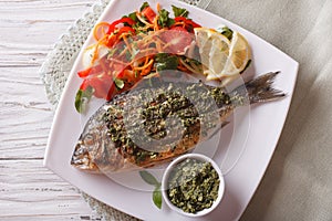 Grilled dorado fish with pesto and salad closeup. horizonta top