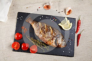Grilled dorado served with fresh cherry tomatoes