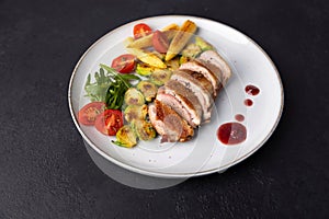 Grilled duck breast fillet with Brussels sprouts, mini corn, cherry tomatoes, arugula and lingonberry sauce.