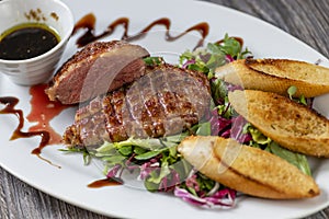 grilled duck breast with honey sauce and salad