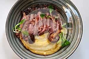 Grilled duck fillet with corn porridge.