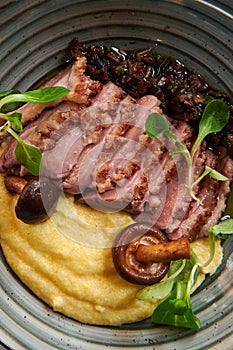 Grilled duck fillet with corn porridge.