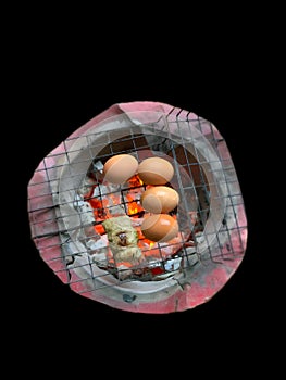 Grilled eggs on a charcoal grill