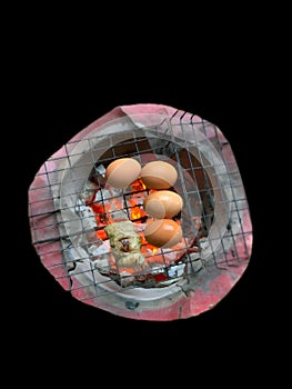 Grilled eggs on a charcoal grill photo