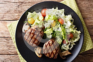 Grilled filet mignon steak with vegetable salad and mushrooms cl