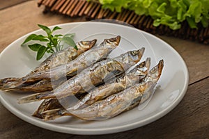 Grilled fish capelin or shishamo on plate