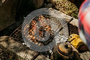 Grilled fish on a fire on a barbecue at a picnic, grilled food on a grill and Turkish teapot 2