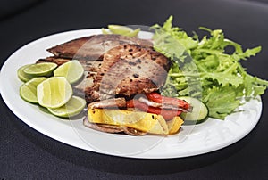 Grilled fish meal on the plate.