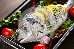 Grilled fish with roasted potatoes and vegetables.