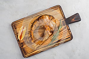 Grilled fish steak on a cutting board