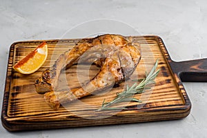 Grilled fish steak on a cutting board