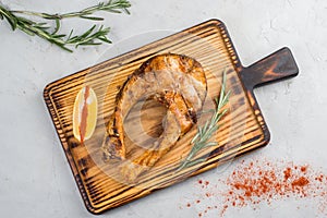 Grilled fish steak on a cutting board