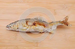 Grilled fish sweetfish with salt Japanese dish ayu no shioyaki on cutting board