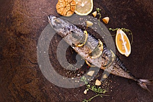 Grilled fish and various vegetables in iron plate