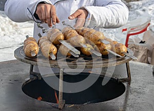 Grilled fresh potato tubers strung on skewers