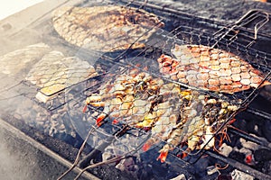 Grilled fresh seafood: prawns, fish, octopus, oysters food background Barbecue / Cooking BBQ seafood on fire