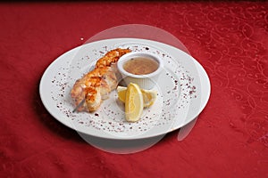 Grilled fried crevettes with red hot chili sauce and lemon slices. photo