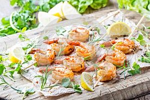 Grilled fried Shrimps Prawns on wooden skewers with spices