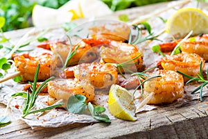 Grilled fried Shrimps Prawns on wooden skewers with spices