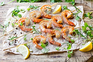 Grilled fried Shrimps Prawns on wooden skewers with spices