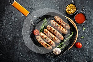 Grilled german bratwurst sausages with rosemary herbs on the grill pan. banner, menu, recipe place for text, top view