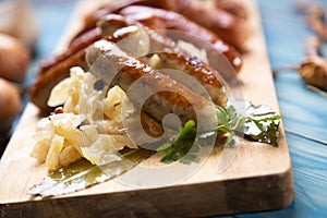 Grilled german sausage links with sauerkraut