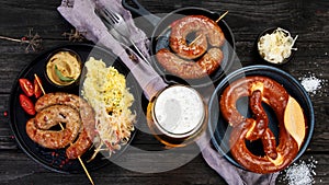 Grilled German sausages on wooden background