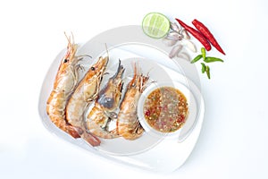 Grilled giant freshwater prawn with seafood sauce in plate on white background.