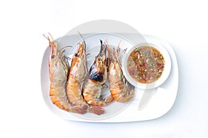 Grilled giant freshwater prawn with seafood sauce in plate on white background.