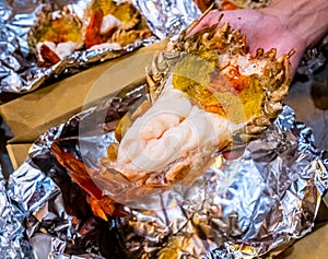 Grilled giant river prawn or big shrimp on aluminium foil with selective focus.A recommended menu for tourists.