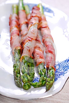 Grilled green asparagus wrapped in bacon