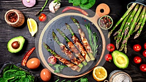 Grilled green asparagus wrapped with bacon. Food recipe background. top view. Long banner format