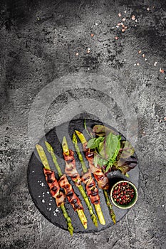 Grilled green asparagus wrapped with bacon. Ketogenic diet. Healthy food, diet menu. vertical image. top view. place for text