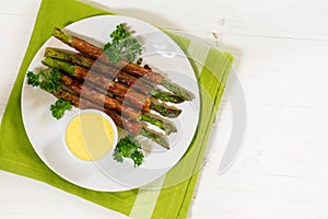 Grilled green asparagus wrapped in prosciutto bacon with hollan