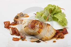 Grilled halibut with tomato concasse. photo