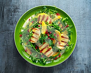 Grilled Halloumi Cheese salad with orange, rocket leaves, pomegranate and pumpkin seed. healthy food