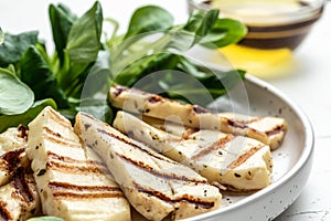 Grilled Halloumi cheese salad on white plate, Cyprus squeaky cheese. Restaurant menu, dieting, cookbook recipe top view