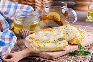 Grilled haloumi cheese with herbs on a cutting board