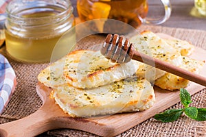 Grilled haloumi cheese with herbs on a cutting board photo