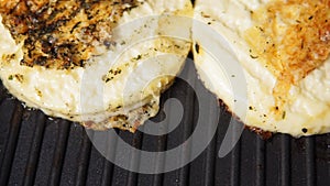 Grilled haloumi cheese with herbs on a grill pan. selective focus