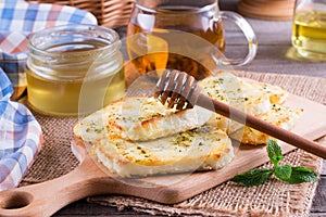 Grilled haloumi cheese with herbs on a cutting board