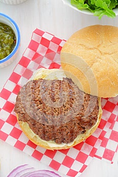 Grilled hamburger with condiments closeup